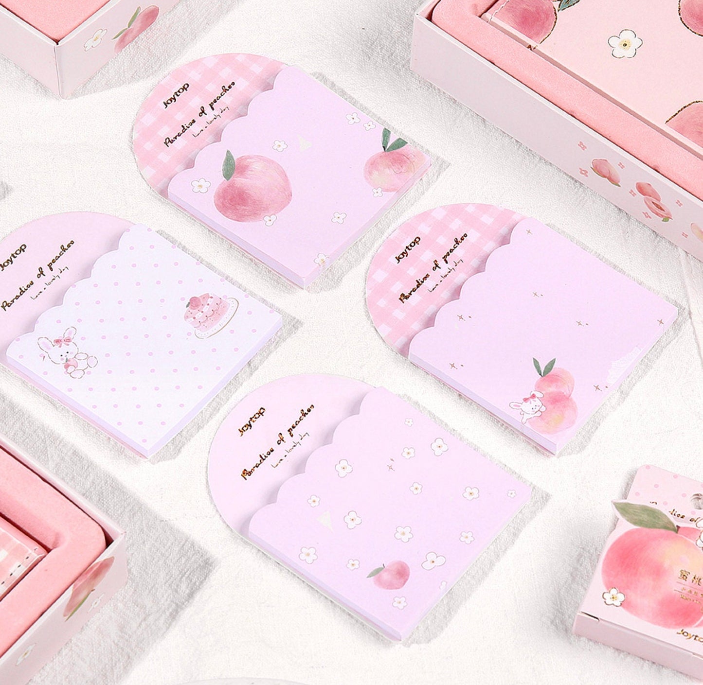 Peach Pink Magnetic Buckle Journal Gift Set with cute peach and pastel pink designs, featuring kawaii stationery items like notebooks, sticky notes with peach and bunny illustrations, and a gingham pattern, arranged in an aesthetically pleasing manner.