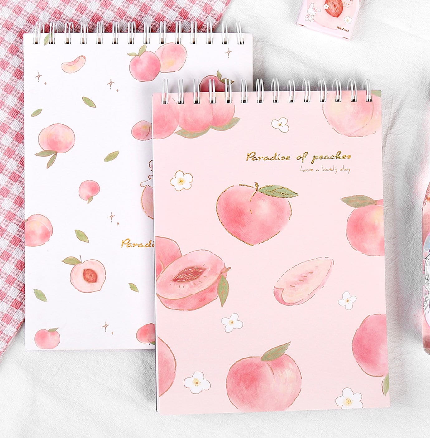 A4 Pink Peach Coil Sketch Book - Cute Planner with charming peach illustrations on a pastel pink cover, featuring coil binding and the words "Paradise of peaches, have a lovely day."