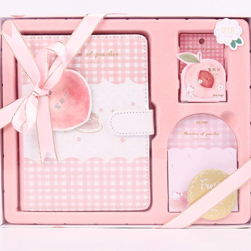 Peach Pink Magnetic Buckle Journal Gift Set in kawaii style with a pink-checkered and scalloped design, featuring matching peach-themed accessories and a pink satin ribbon bow.