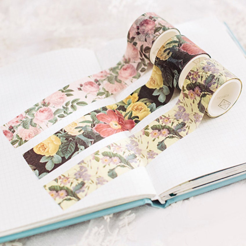 Floral Sakura Mail Kit including washi tape and stickers, beautifully displayed in an open planner, perfect for scrapbooking and journaling.