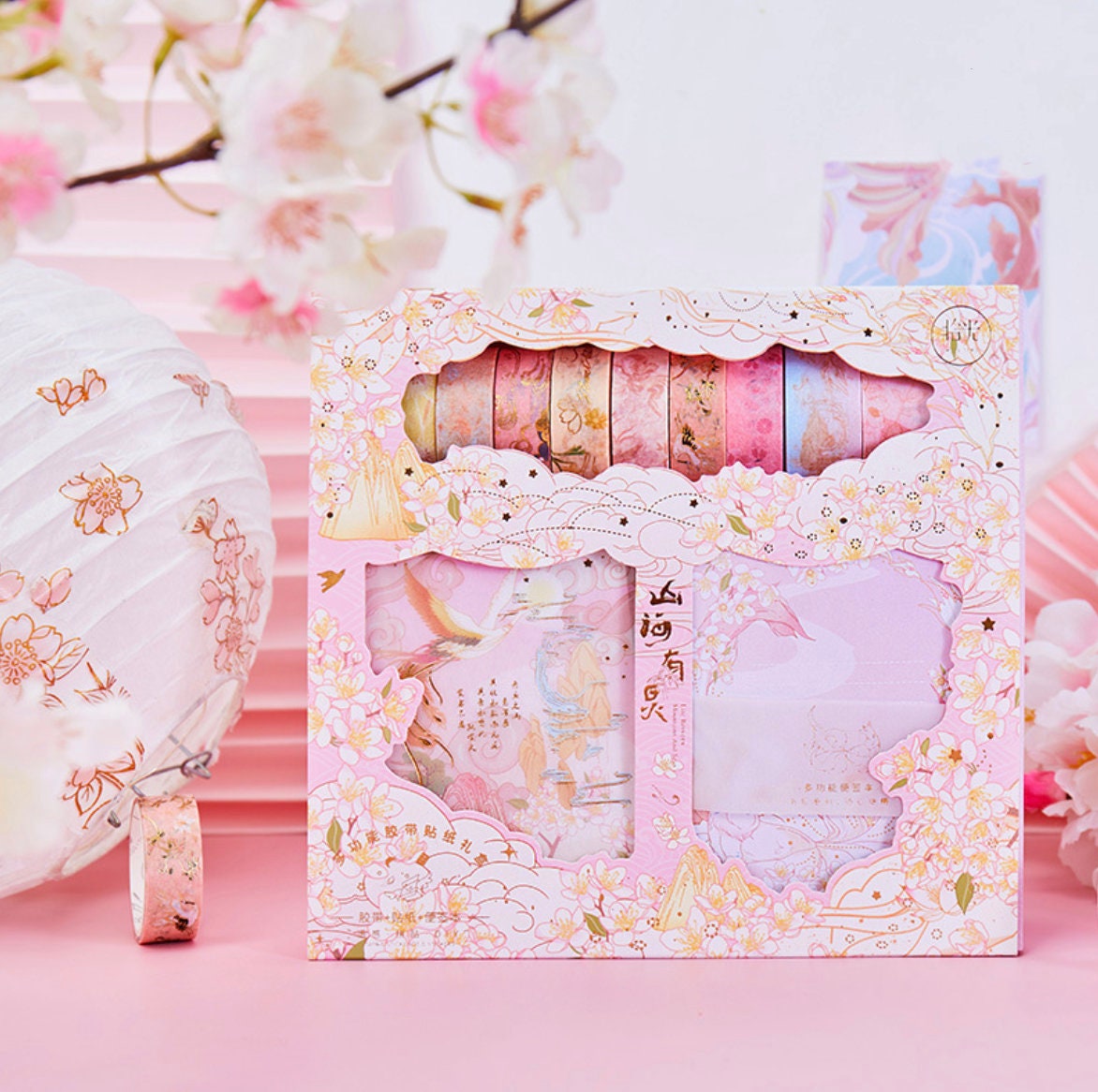 Mountains and Sea Washi Tape Set in pink packaging with delicate cherry blossom designs, perfect for craft and DIY projects, ideal as a cute stationery gift.