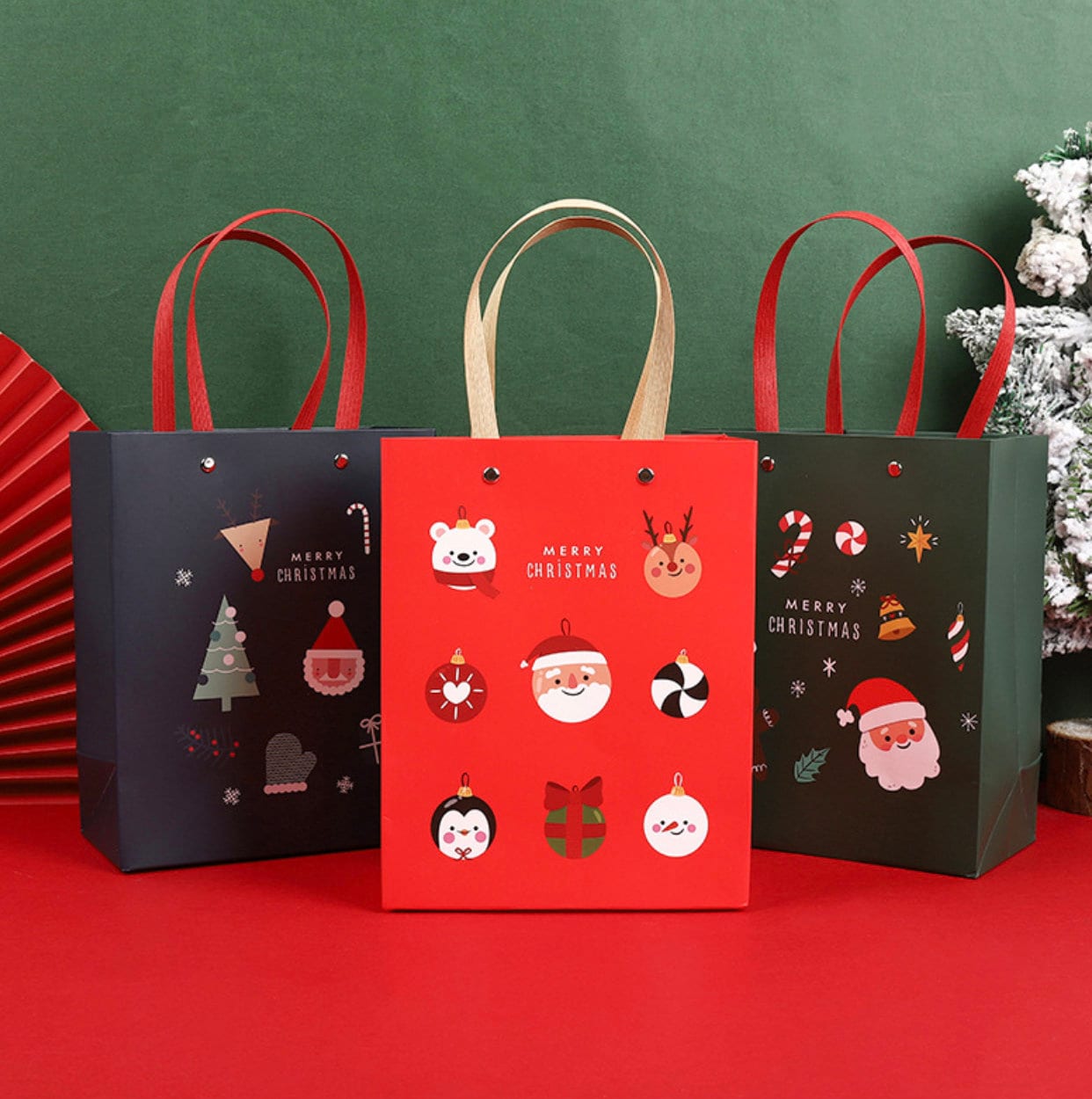 Christmas paper gift bags with handles, Santa design, featuring festive graphics like Santa Claus, reindeer, Christmas tree, and ornaments.