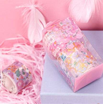 Pink & Gold Flower Washi Tape Set - 5 Rolls displayed on a pastel background with pink feathers and shredded paper.