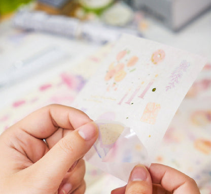 Close-up of hands peeling a colorful sticker from the Red Fruit Washi Tape Set, perfect for bullet journal decoration.