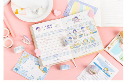 Blue Candy Washi Tape Set displayed in a journal with 10 rolls of mixed width tapes featuring cute, kawaii designs on a pink background with other stationary items.