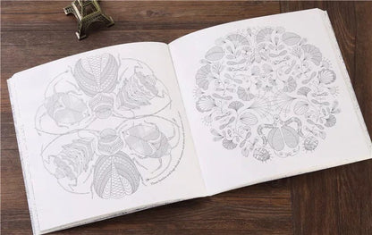 Animal and plant coloring therapy book open to intricate, nature-inspired designs, ideal for all ages, stress relief, and relaxation with adult coloring activities.