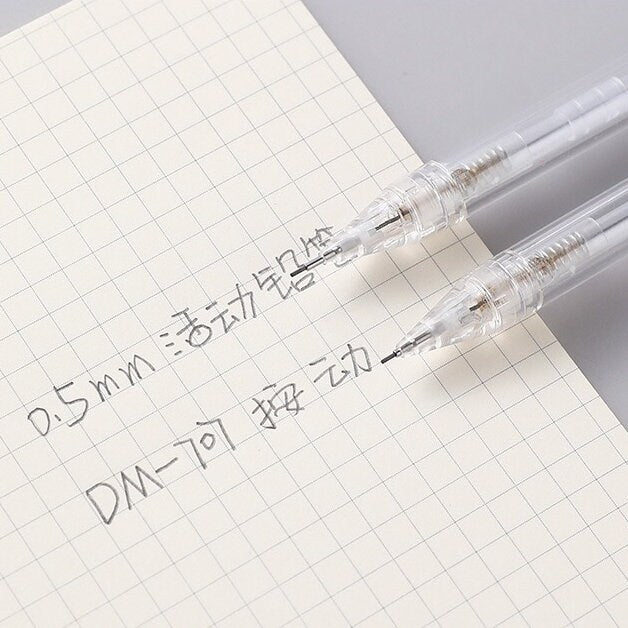 0.5mm transparent mechanical pencil for office and student stationery, shown writing on grid paper.