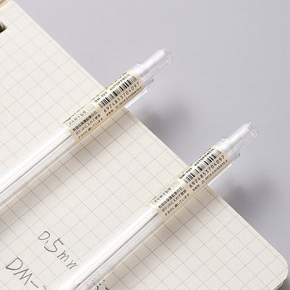 0.5mm transparent mechanical pencil for office and student stationery on grid notebook background