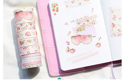 Peach Pink Washi Tape Set - 10 Rolls displayed with notebook decorated with creative peach-themed washi tape designs in pastel colors.