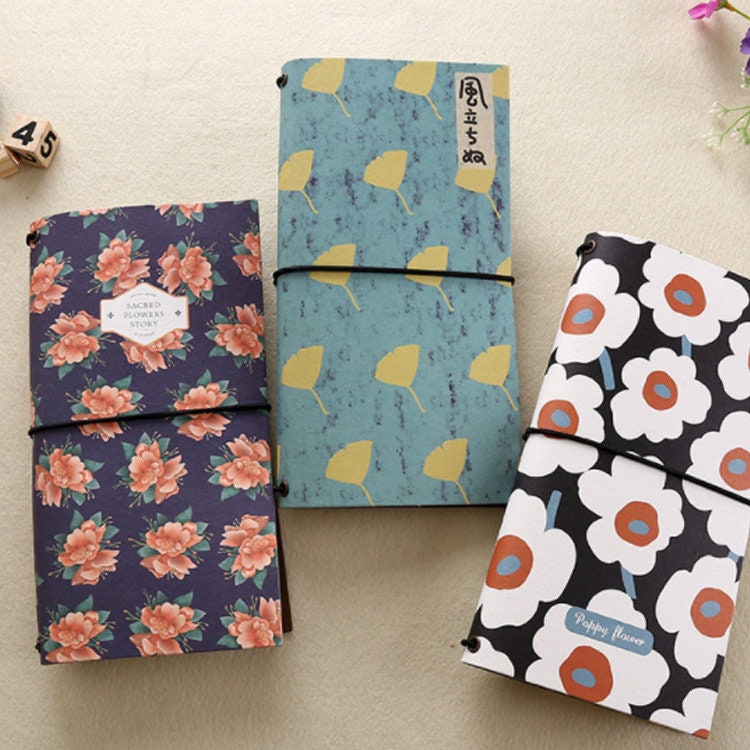 Spring Flower Kraft Journals - Recycled Paper Set featuring floral designs with pink and red blossoms, blue leaves, and abstract white and orange flowers. Eco-friendly stationery perfect for journaling.