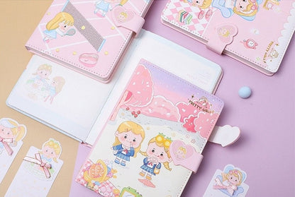 Pink leather journal with magnetic buckle and bookmark featuring kawaii illustrations of cute characters on desks.