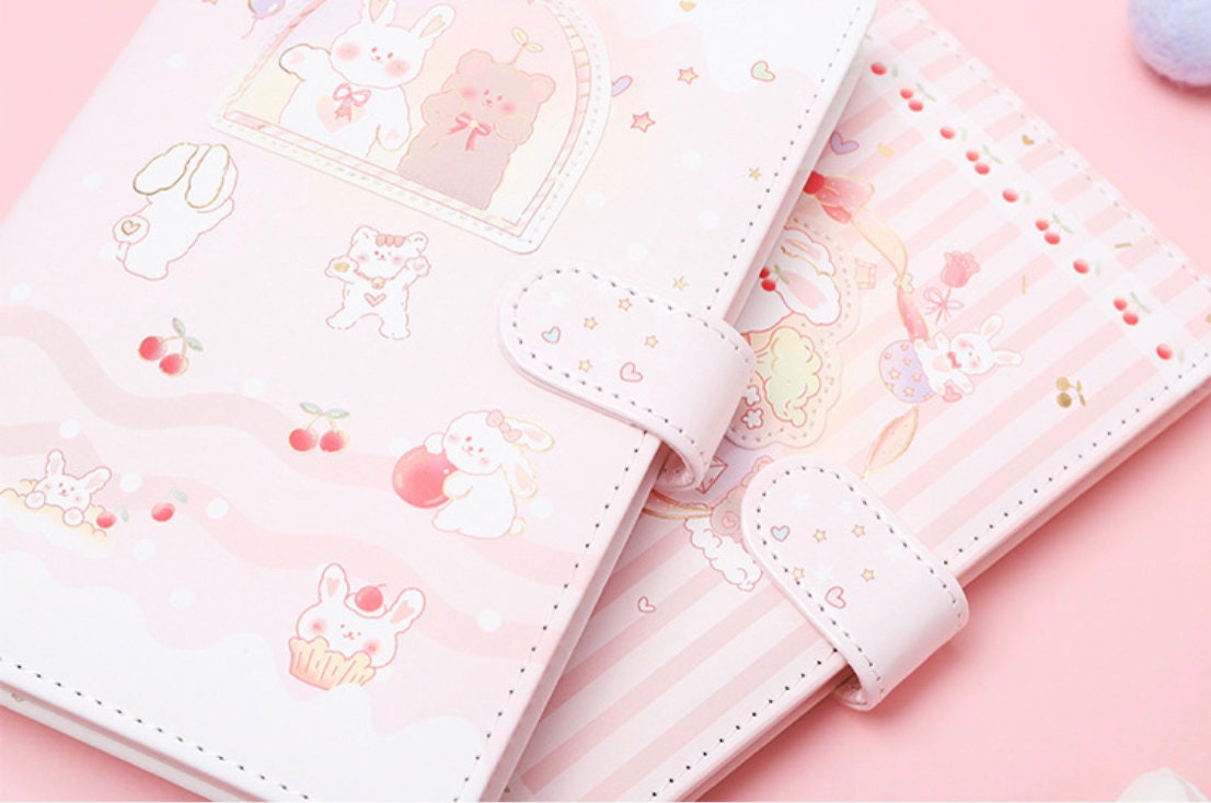 Sweet Cherry Leather Journal A5 Planner with Magnetic Buckle featuring kawaii bunny and bear illustrations in pastel pink and white colors.