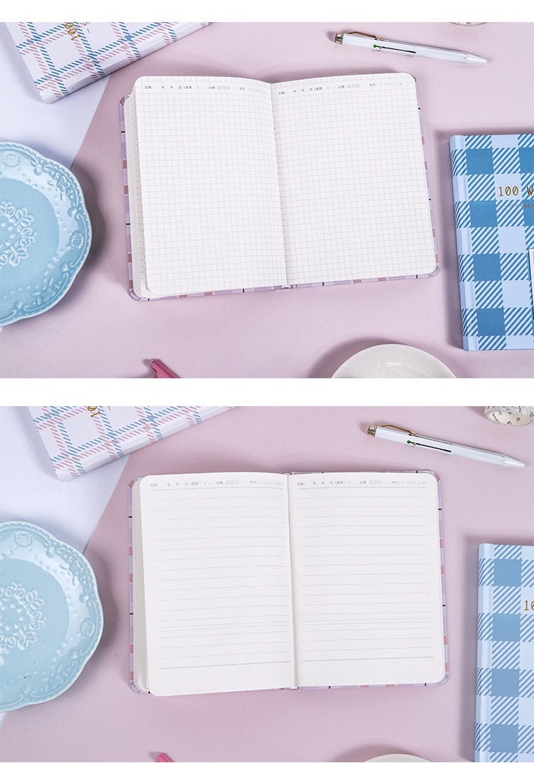 Hard Cover A5 Minimalist Grid Pocket Planner with open pages showcasing grid and lined layouts, surrounded by stylish stationery and soft pastel accessories on a pink background.