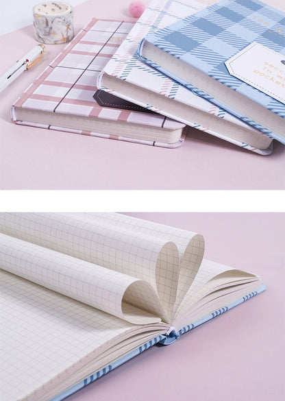 Hard Cover A5 Minimalist Grid Pocket Planner with stylish pastel covers and grid paper layout, stacked on pink background, perfect for organizing tasks and notes.