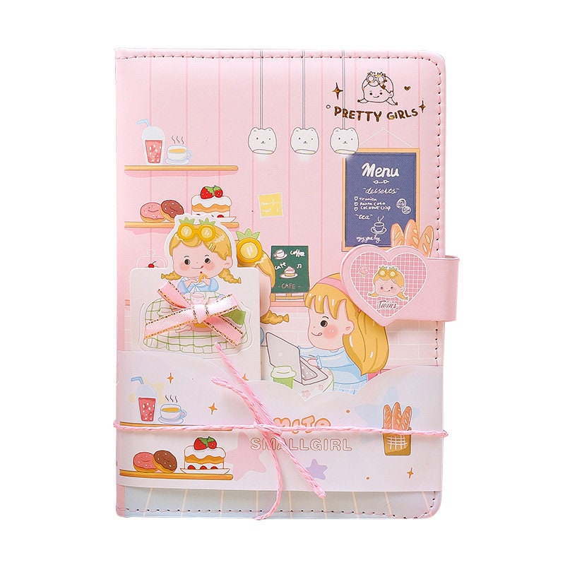 Pink leather journal with magnetic buckle and bookmark featuring a kawaii design. Adorned with cute illustrations of characters in a bakery setting, pastel colors, and playful decorations. Perfect stationery for girls.