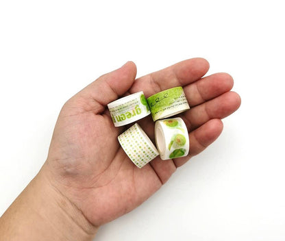 Green Plum Washi Tape & Sticker Set for Journals held in a hand, featuring various designs with green plum patterns, perfect for scrapbooking and journaling.