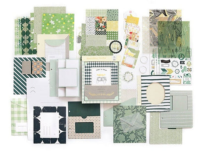 Aesthetic scrapbook paper assortment with various decorative journaling supplies in green and pastel tones, including patterned papers, stickers, and labels in kawaii style. Perfect for scrapbooking, bullet journals, and DIY crafts.