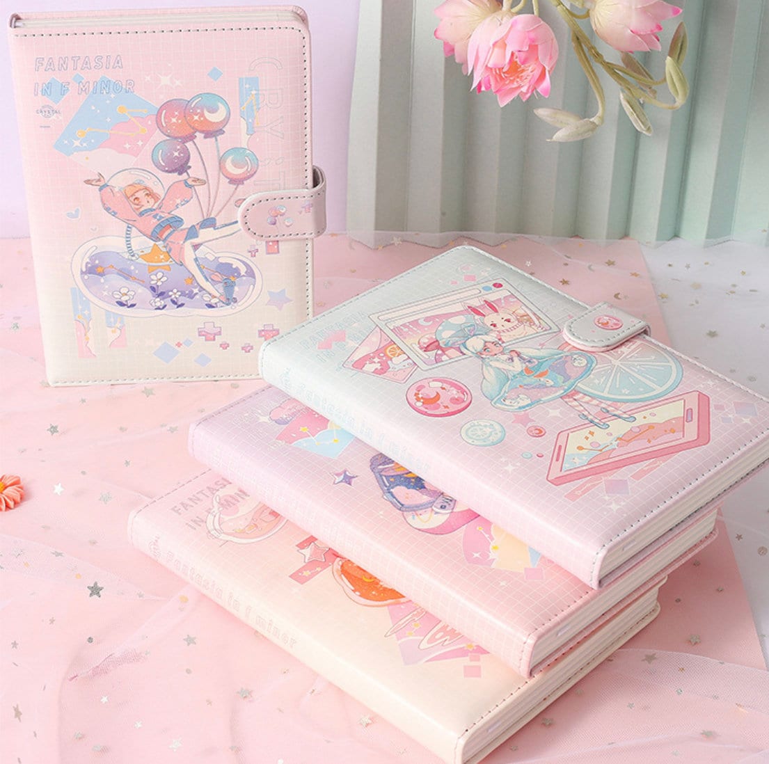 Fantasia in F Minor Journal with leather cover and bookmark featuring kawaii design, laying on a pink fabric with stars.