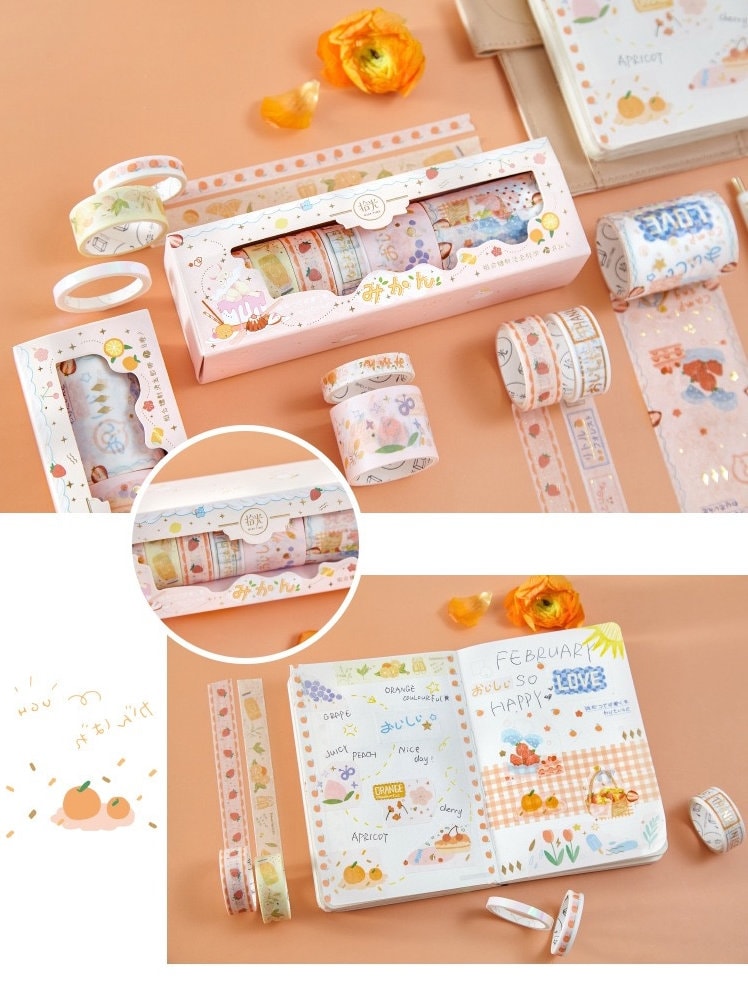 Mercury World Washi Tape Set - 8 Rolls with floral and fruit designs, displayed in a pink box and used to decorate scrapbook pages on an orange background with flowers.