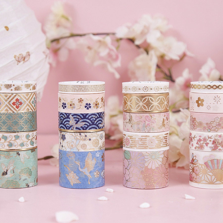 Gold Foil Washi Tape Set - Pink Black Design, featuring elegant patterns in pink, black, and gold, with floral and geometric designs, ideal for scrapbooking and decorative projects, set against a pastel pink background with flowers.