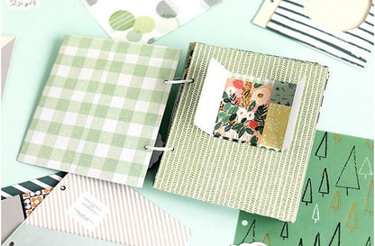 Aesthetic scrapbook paper in green and plaid patterns, decorative journaling supplies featuring floral design and creative layouts, perfect for DIY projects and planners.