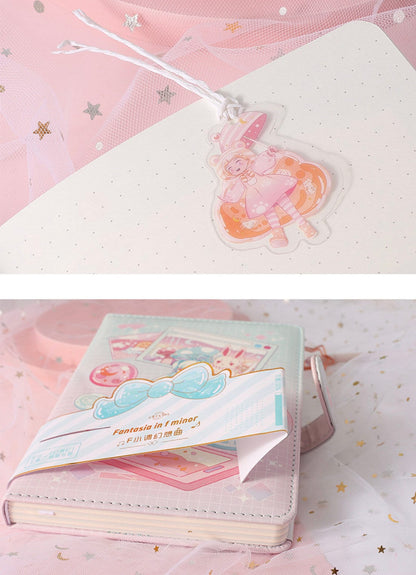 Fantasia in F Minor Journal with leather cover and bookmark, featuring a cute kawaii character design and pastel colors.