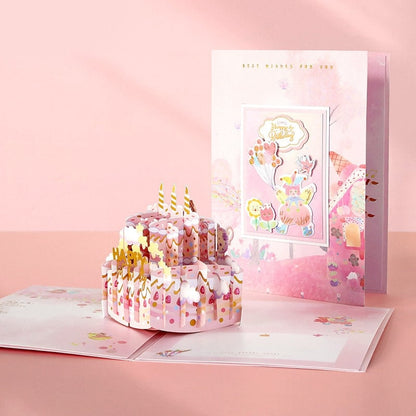 3D Pink Cake Pop Up Card - Happy Birthday with intricate design featuring a pink birthday cake adorned with flowers, candles, and colorful decorations; pastel colors and a cute, kawaii style make it the perfect birthday greeting card.