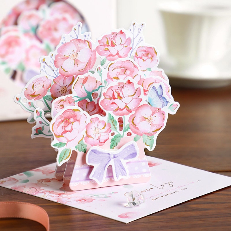 3D Pink Flower Pop-Up Greeting Card with Rose and Lily design, featuring intricate pink flowers and a delicate butterfly, perfect for special occasions and celebrations.