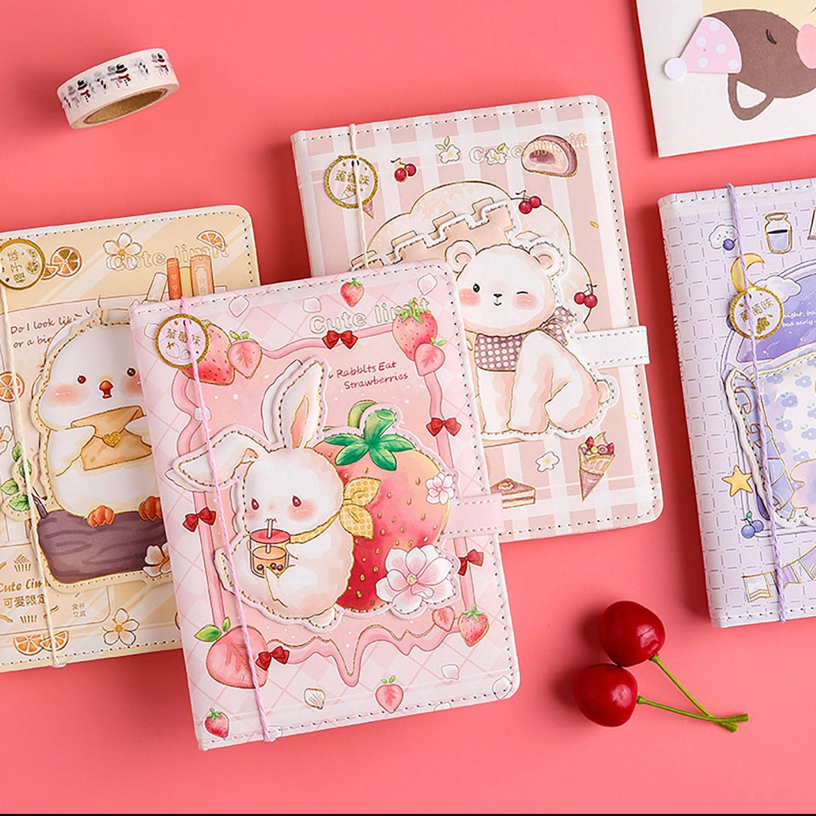 A5 leather journal with cute animal designs and bookmarks featuring a rabbit, bear, and chick on a pink and pastel-colored background, perfect for kawaii stationary lovers.