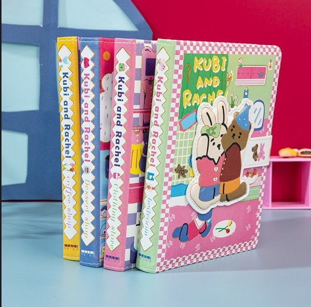 Kubi and Rache Leather Notebook - A5 Magnetic Buckle featuring cute kawaii characters on colorful covers in pink, blue, yellow, and purple, ideal for journaling and note-taking