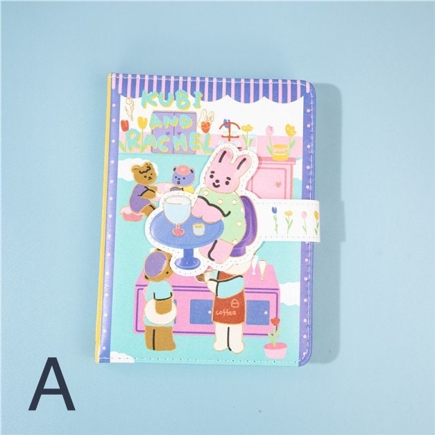 Kubi and Rache Leather Notebook - A5 Magnetic Buckle featuring cute kawaii animal characters in a pastel color cafe scene, with a decorative magnetic closure.