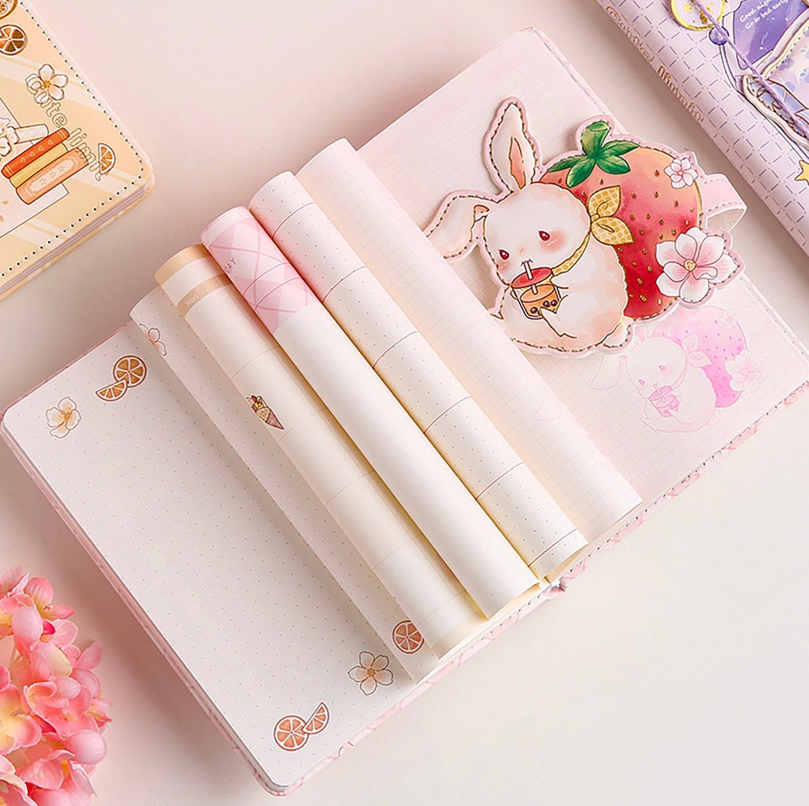 A5 leather journal with cute animal design, including a bunny and strawberry illustration, and attached bookmark; kawaii stationery.