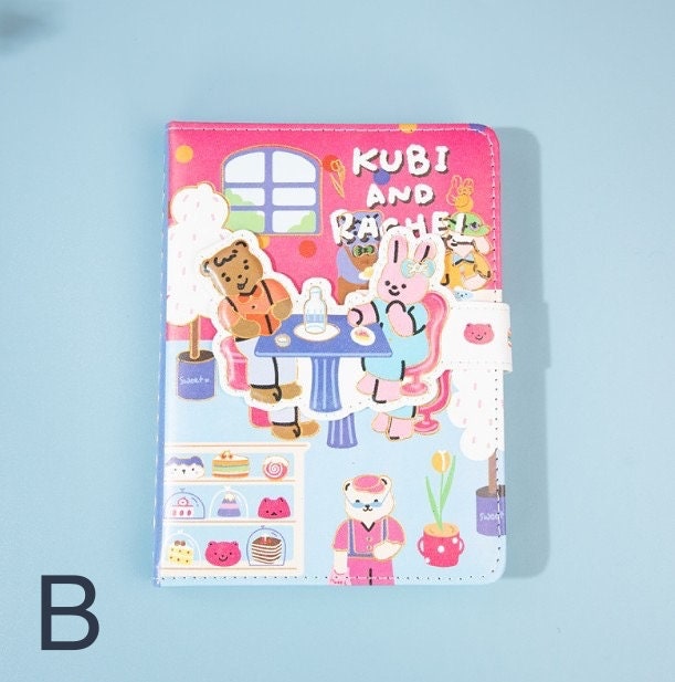 Kubi and Rache Leather Notebook - A5 Magnetic Buckle with adorable animal cafe scene and vibrant pink and blue colors. Perfect for kawaii stationery lovers.