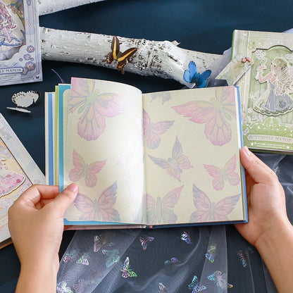 Butterfly Manor A5 hardcover notebook with bookmark, featuring pastel butterfly illustrations on open pages, with hands holding the notebook.