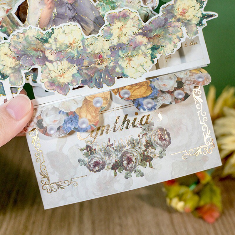 Aesthetic oil painting pop-up greeting card with intricate floral designs and gold accents.