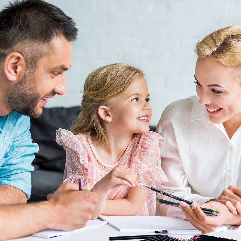 Family enjoying art with vibrant watercolor brush pens, precision soft tips, set of 48, happy child with parents, artistic bonding activity.