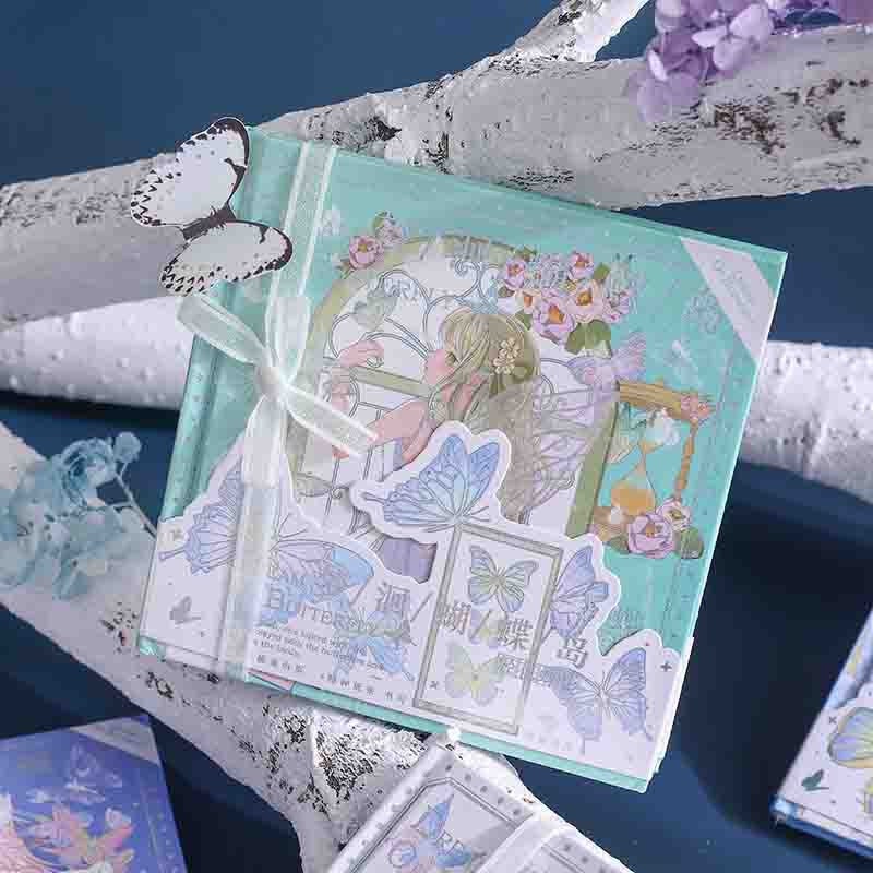 Dream of Butterfly Hardcover Notebook with Bookmark in pastel colors featuring whimsical fairy and butterfly illustrations, tied with a white ribbon.