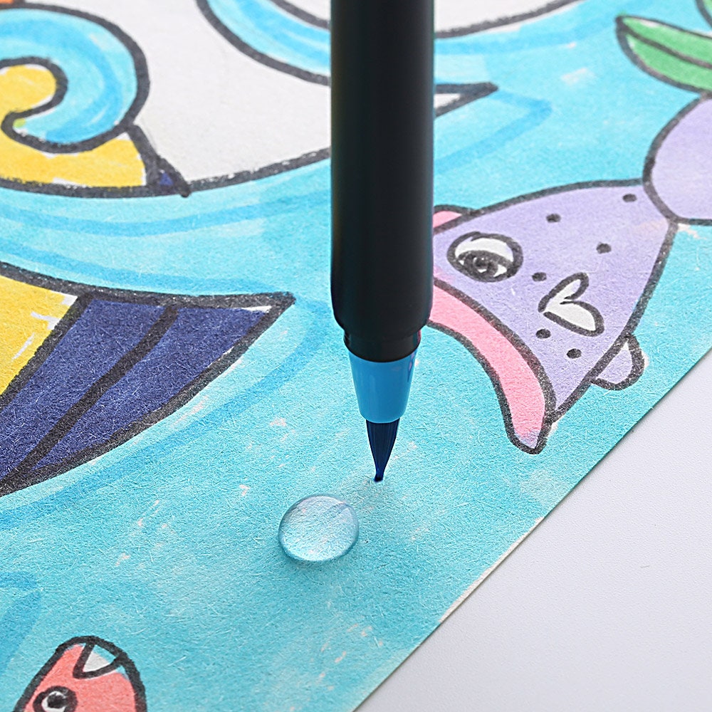 Close-up of a blue watercolor brush pen from the 48 Vibrant Watercolor Brush Pens set, demonstrating precision soft-tip usage on a colorful, detailed illustration.