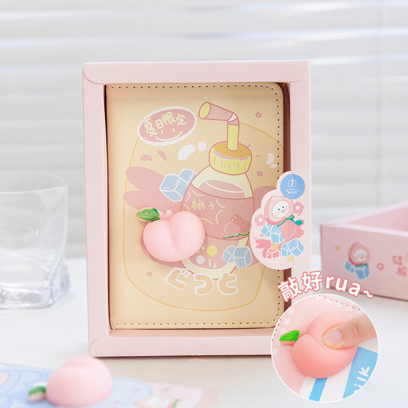 Silicone Peach Soft Leather Planner with 224 pages in peach and pastel colors, featuring a 3D peach design, packaged in a cute pink box with kawaii illustrations.