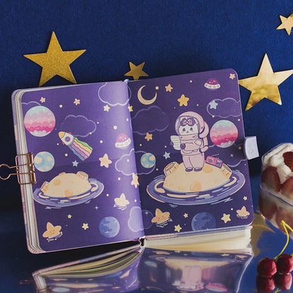 Kawaii style Rabbit Pudding Leather Journal with Bookmark featuring a cute bunny in an astronaut suit on a planet with stars, moons, and rockets on a purple background.