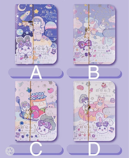 Rabbit Pudding Leather Journal with Bookmark in four kawaii designs: A) Space theme with purple background, B) Fantasy landscape with pink and blue background, C) Strawberry jam and spoon illustration with pastel pink background, D) Cute animals in a donut float with white and pastel background.