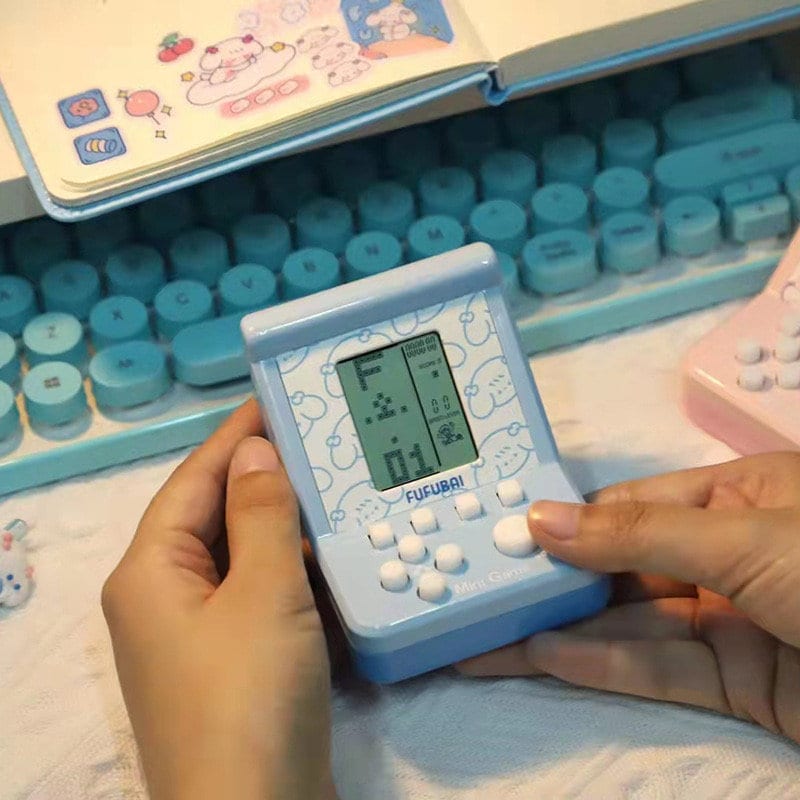 Mini Game Player for Kids - Portable Puzzle Gaming Device in Pastel Blue with Cute Design.