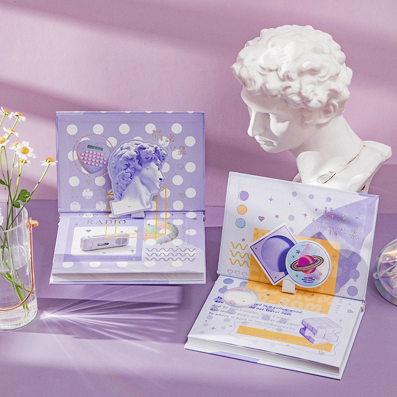 Emotional Palette A5 Notebook with Bookmark and 3D Pages featuring purple cover, intricate 3D art pages, and a classical bust statue on a pastel lavender background.