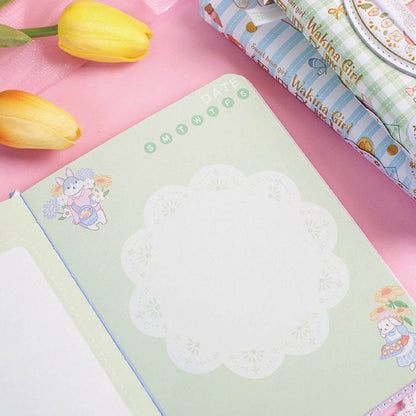 Magnetic Buckle Leather Journal - Sweet Bean Girl with cute animal illustrations and floral designs, open page view with pastel colors, kawaii stationery on a pink background.