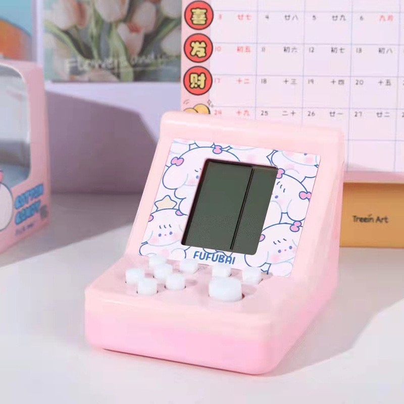 Mini Game Player in pink with kawaii design on screen, kids puzzle gaming device for fun and learning.