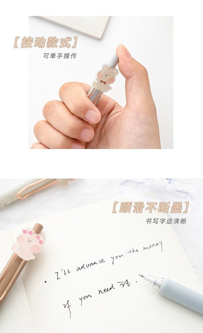 Kawaii animal gel pen in hand with cute bear design on top, writing smooth black ink in a notebook. 0.5mm tip for fine lines, 6 pack of adorable stationery for school or office.