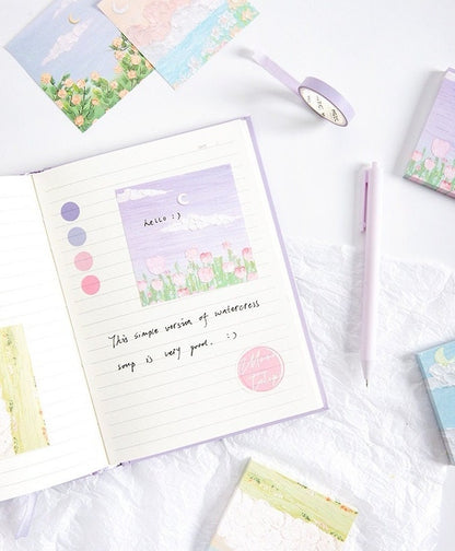 Flower Field Sticky Notes Set - 120 Pieces featuring colorful, floral-themed sticky notes in a planner, next to a lavender pen and decorative tape on a white background.