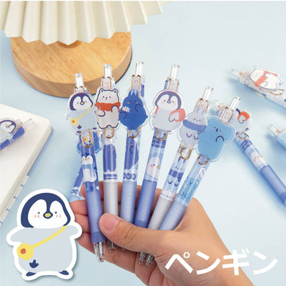 Love the Earth Gel Pen - 0.5mm Micro Point with cute animal designs including penguins, bears, and more, held in hand on a light blue background.