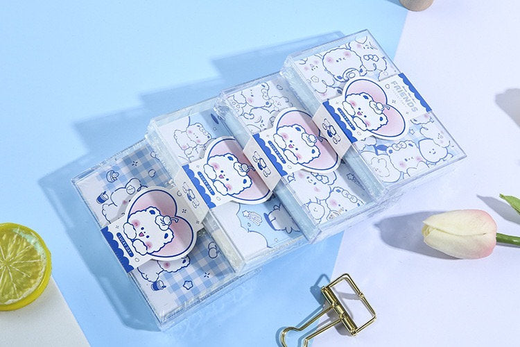 Toffee Diary Sticky Notepad with PVC Card Holder in kawaii style featuring cute bear illustrations and pastel colors, arranged on a light blue and white background with decorative items.