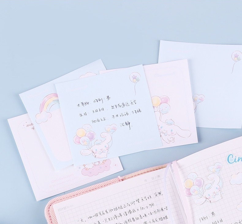 Cinnamoroll Notepad Set with 4 adorable kawaii designs, featuring 48 pages of cute stationery with pastel colors, balloons, and rainbows.